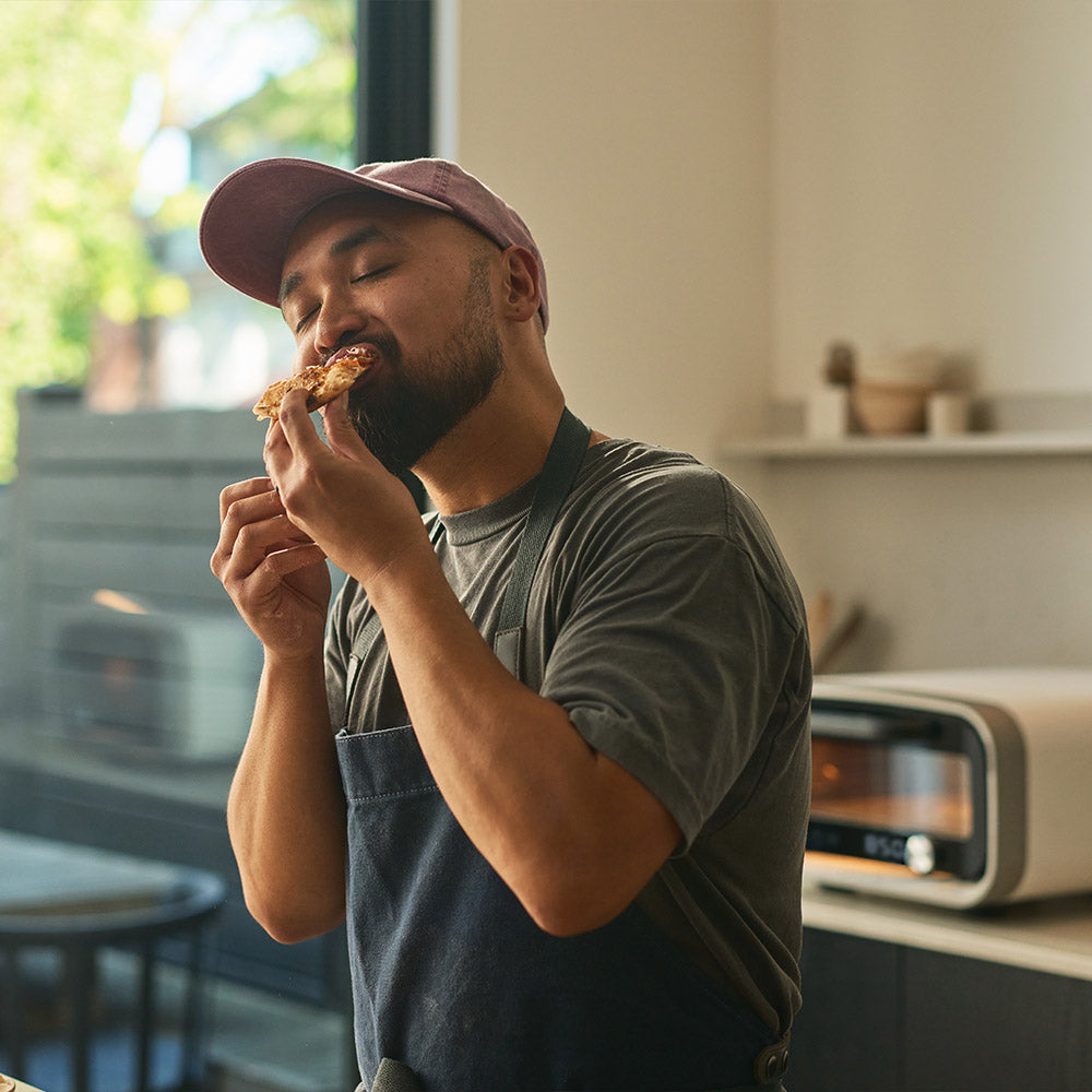 A man eating a slice of pizza