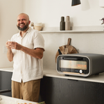 Man standing in a kitchen with the Volt 2 Electric Pizza Oven on the counter.