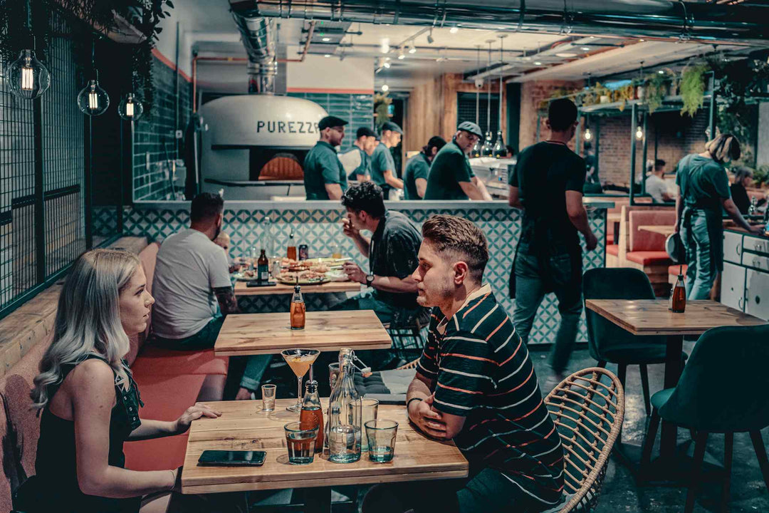 People sitting at tables in a vegan pizza restaurant