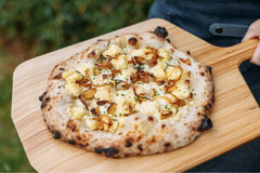 mashed potato pizza on bamboo pizza peel