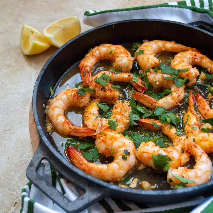 Prawns cooked in Ooni cast iron skillet pan topped with lemon and parsley