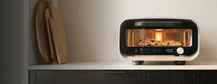 koda 2 gas pizza oven, turning peel and ooni pizza peel in front of orange background