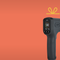 The Ooni thermometer, turning peel and perforated peel on an orange background