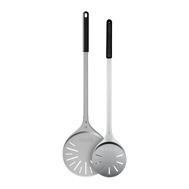 Two metal turning peels with black handles on a white background