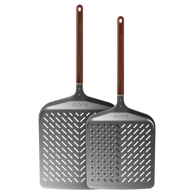 Two Ooni signature pizza peels with wooden handles on a white background
