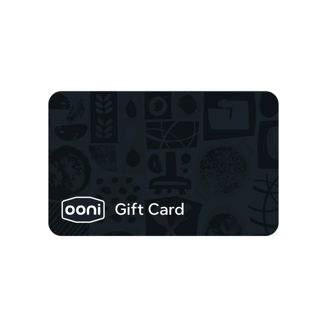A dark charcoal gray Ooni gift card with a subtle pattern of culinary and kitchen-themed illustrations, featuring the white 'ooni' logo and 'Gift Card' text near the bottom left, shown on a plain white background.