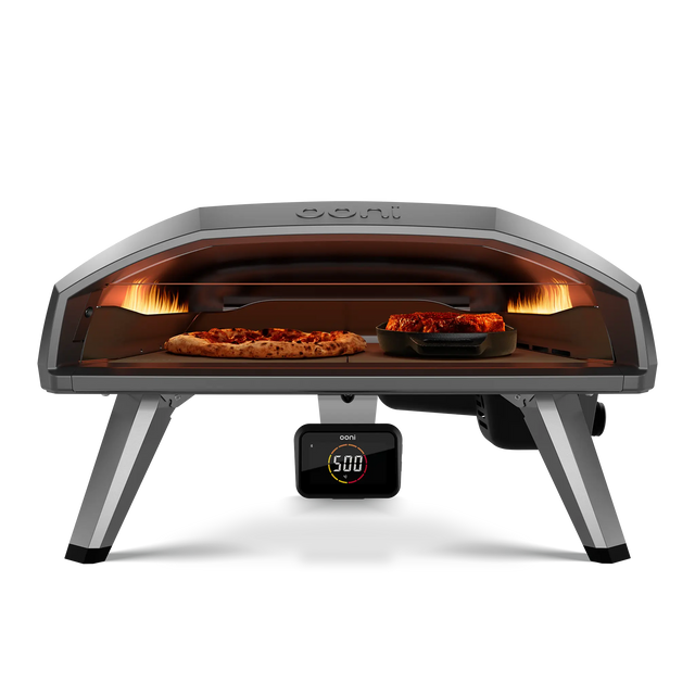 Ooni Koda 2 Pro gas pizza oven front view with pizza and cast iron pan side by side 