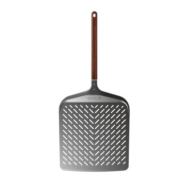 The Ooni Signtaure Pizza Peel with a wooden handle on a white background