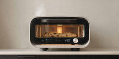 Ooni Volt 2 pizza oven on a kitchen counter with a pizza inside