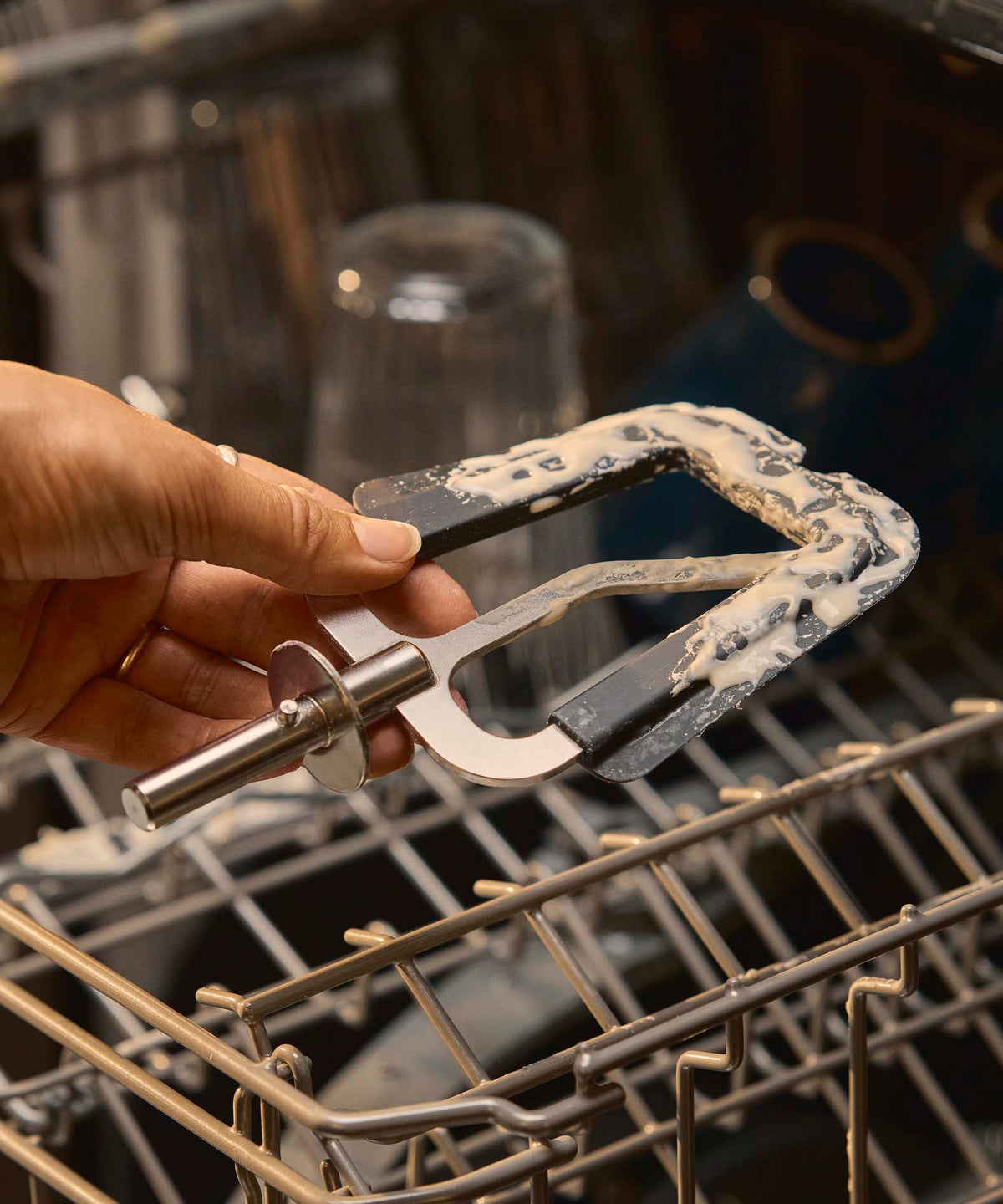 A person placing the flexible beater attachment for the Halo Core in the dishwasher