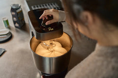 Person using a Halo Pro mixer to knead dough in a kitchen setting