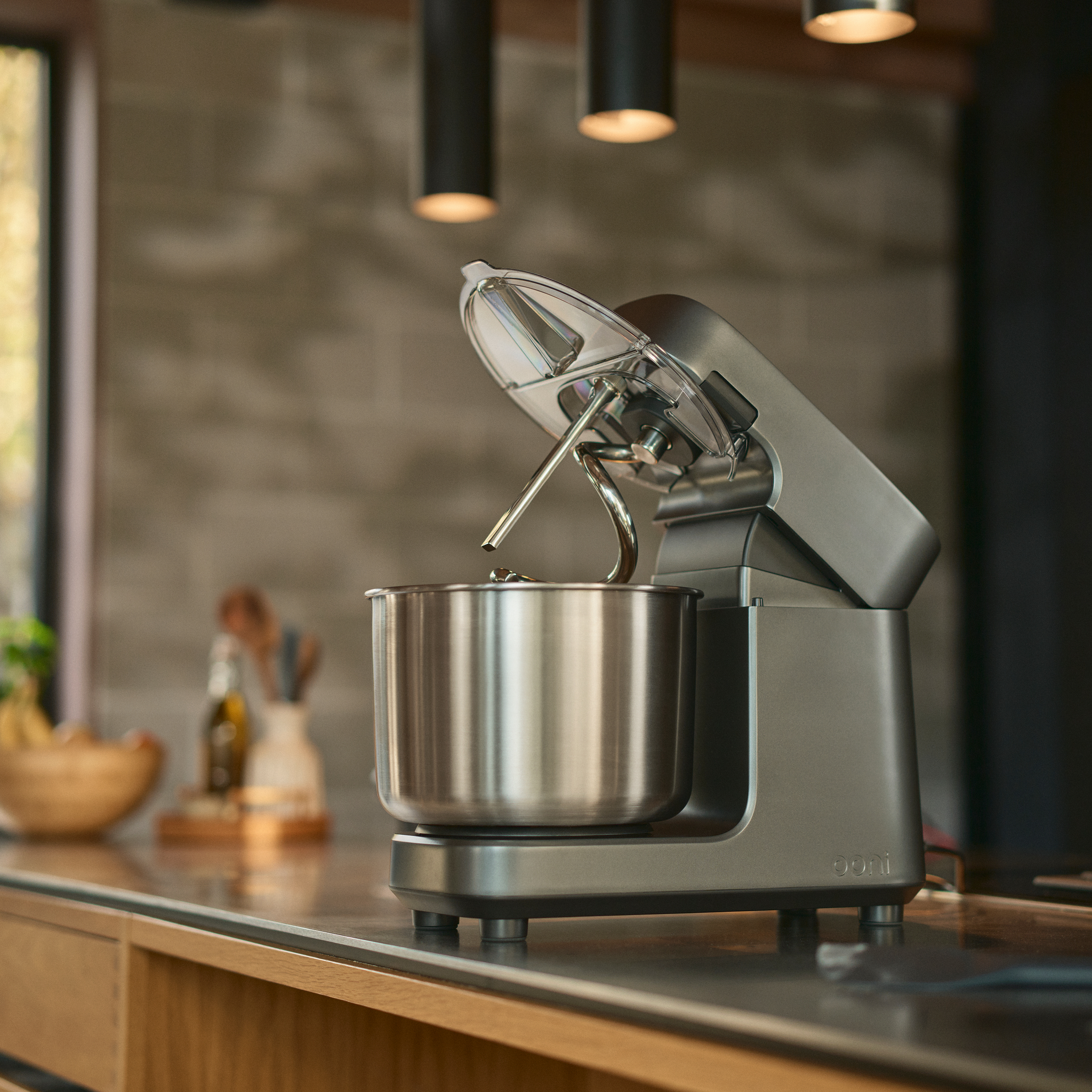 Ooni Halo Pro Spiral Mixer on a kitchen counter with blurred background