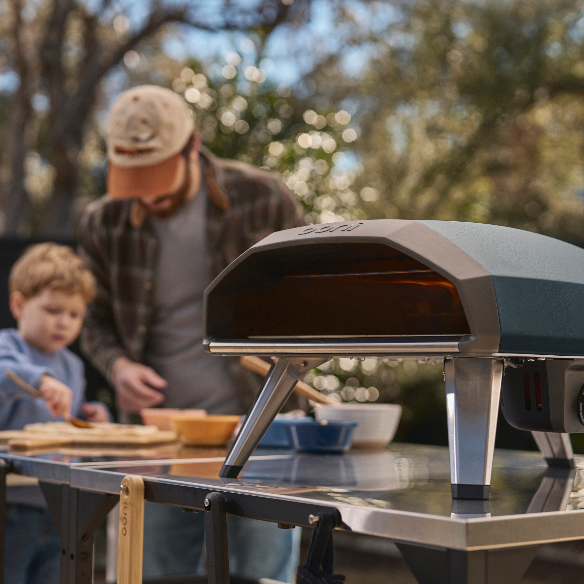Ooni Koda 2 Gas Powered Pizza Oven with child and man in the background