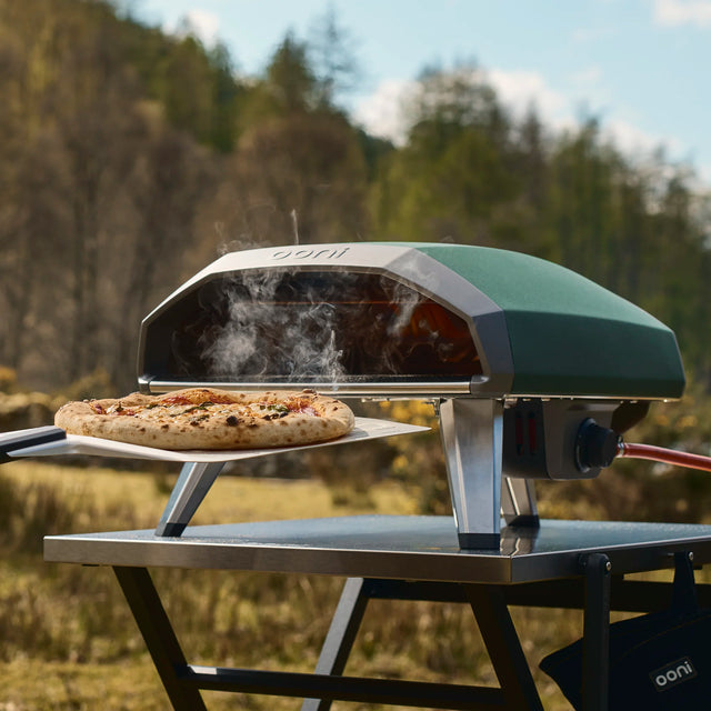 Highland Green Koda 2 cooking a pizza outdoors with a natural background