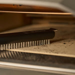 Close up of the oven brush cleaning the pizza stone on the Koda 2 Pro