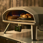 Ooni Koda 2 Pro with a cooked chicken inside on the rotating stone