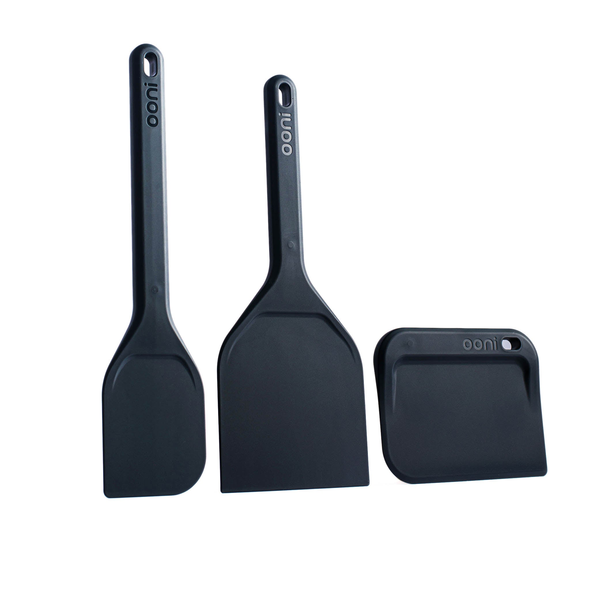 Set of three black spatulas with Ooni branding on a white background