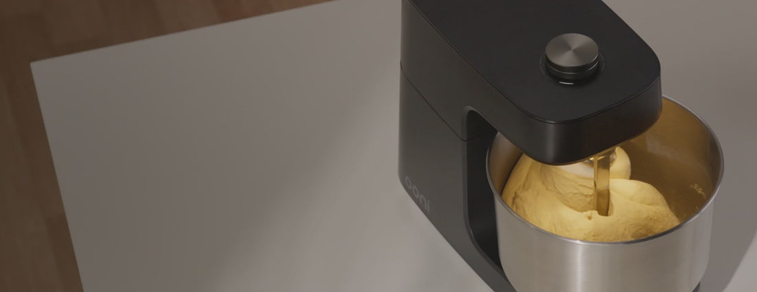 A video showing the Volt 2 Oven and Halo Core Spiral Mixer in a modern kitchen setting that cuts to footage of dough being mixed in the mixer followed by a cooked pizza on a bamboo peel.