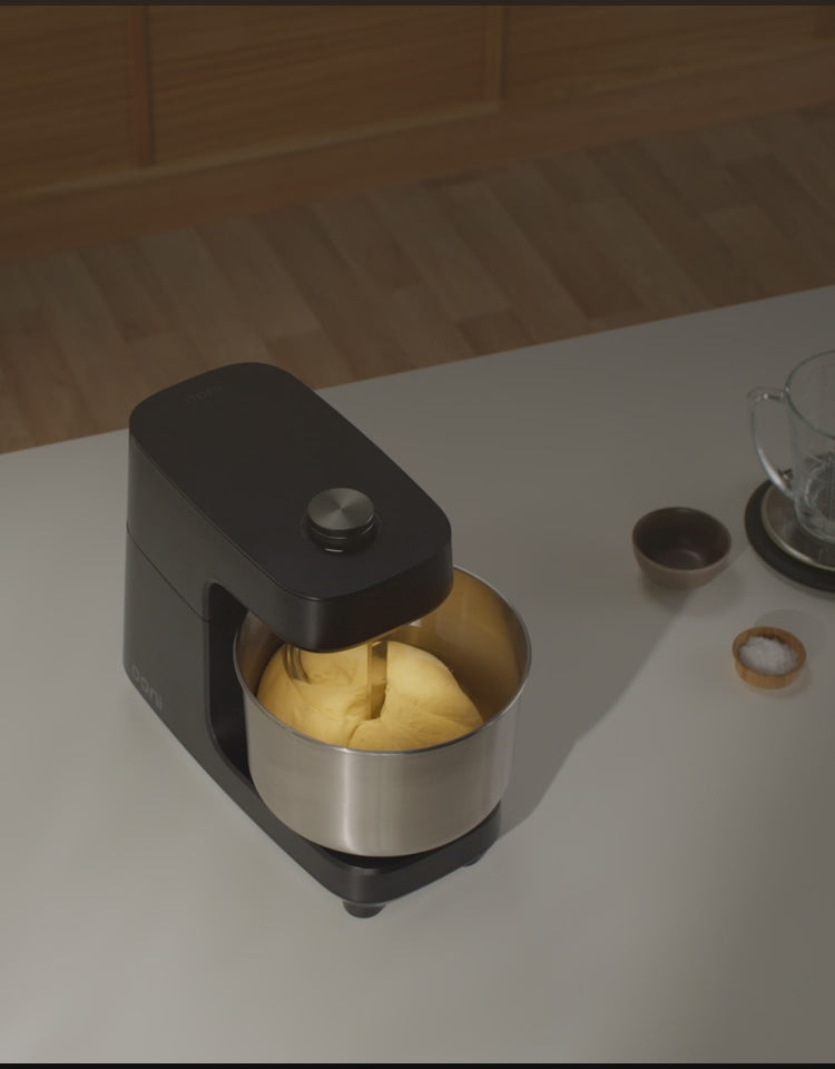 A video showing the Volt 2 Oven and Halo Core Spiral Mixer in a modern kitchen setting that cuts to footage of dough being mixed in the mixer followed by a cooked pizza on a bamboo peel.
